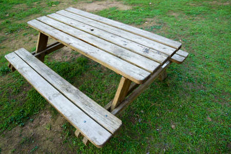 Close-up of a wooden picnic table.