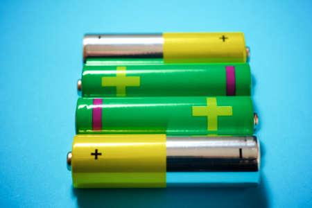 Small batteries on a blue table.