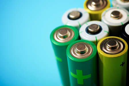 Small batteries on a blue table.の写真素材