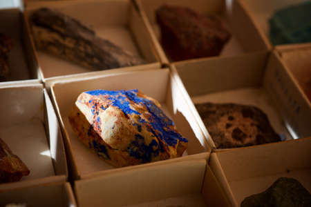 Collection of minerals in cardboard boxes.