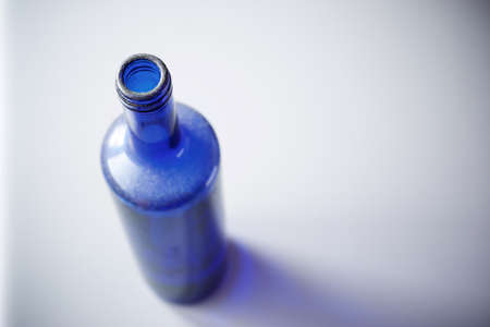 Blue glass bottle on a table.の写真素材