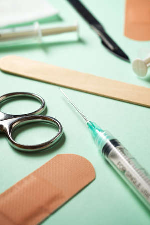 First aid kit on a green table.