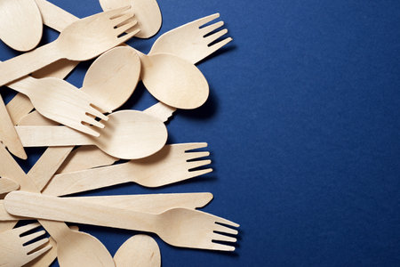 Disposable wooden cutlery on a table.の写真素材