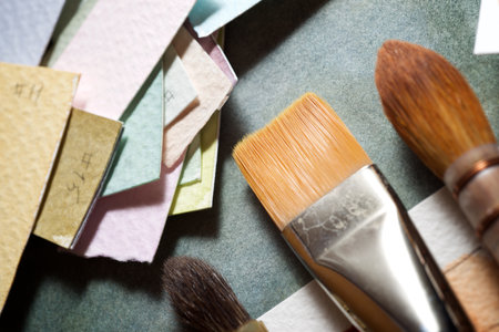 Watercolorist paintbrushes on a painted paper.の写真素材