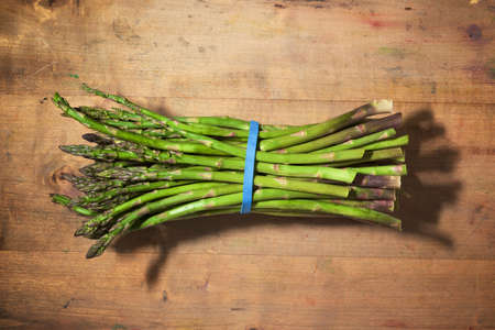 Wild asparagus on a wood table.の写真素材