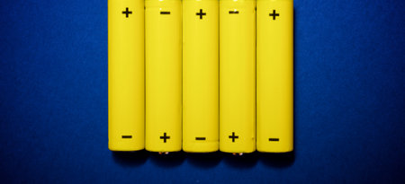 Small batteries on a blue table.の写真素材