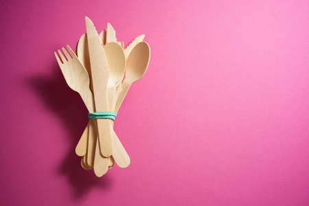 Disposable wooden cutlery on a table.の写真素材