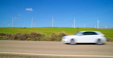 Windmills for electric power production and car, Zaragoza province, Aragon in Spain.