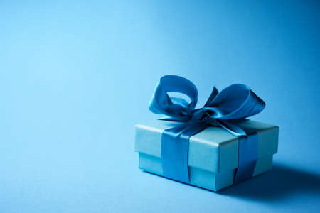 Luxury box tied with a blue ribbon.