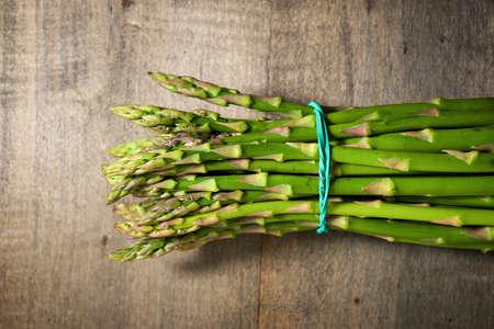 Wild asparagus on a wood table.
