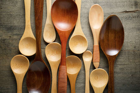 Collection of spoons on a wood table.の写真素材