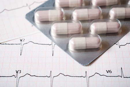 Forefront of a medicine pills in blister pack and electrocardiogram.の写真素材