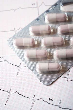 Forefront of a medicine pills in blister pack and electrocardiogram.の写真素材