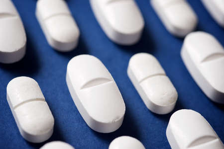 Pills on a blue table.