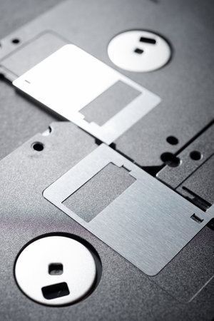 Old floppy disks on a black table.の写真素材
