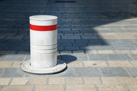 Close-up of a bollard on a cobblestone street in Pau, France.の写真素材