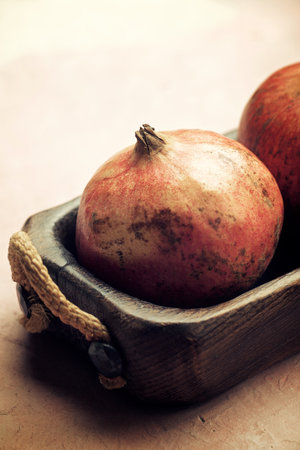 Pomegranates view on a wood trayの写真素材