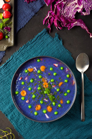 Red cabbage soup with peas and carrots.の写真素材