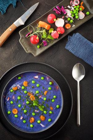 Red cabbage soup with peas and carrots.の写真素材