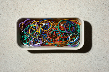 Rubber bands in an elongated box on a stone tableの写真素材