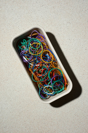 Rubber bands in an elongated box on a stone tableの写真素材