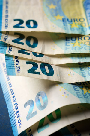 Twenty euro bills stacked on a table.の写真素材