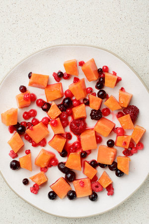 Papaya pieces and berries in a dishの写真素材