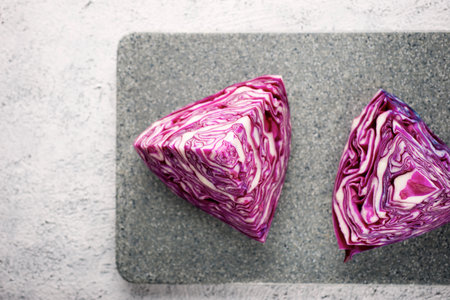 Red cabbage pieces on a chopping boardの写真素材