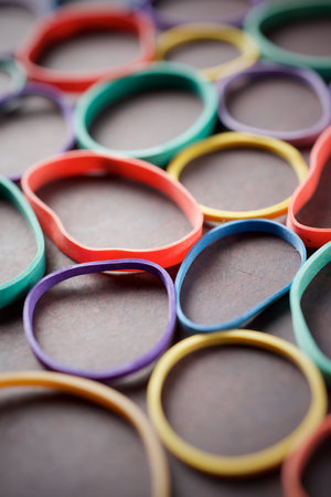 Colorful group of messy elastic rubber bands on a tableの写真素材