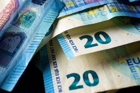 Twenty euro bills stacked on a table.の写真素材