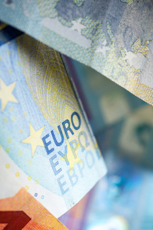 Euro bills stacked on a table.の写真素材