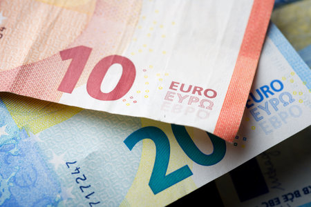 Euro bills stacked on a table.の写真素材