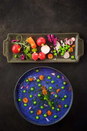 Red cabbage soup with peas and carrots.の写真素材