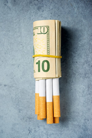 Cigarettes wrapped in dollar billsの写真素材