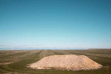Stones piled up in a crop field and clear sky in Spainの写真素材