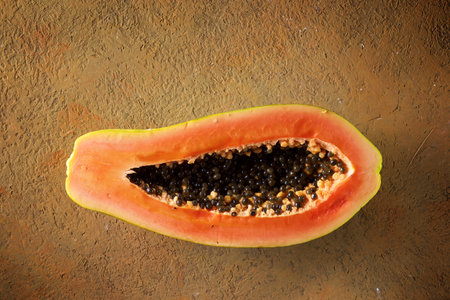 Papaya chunk on a brown tableの写真素材