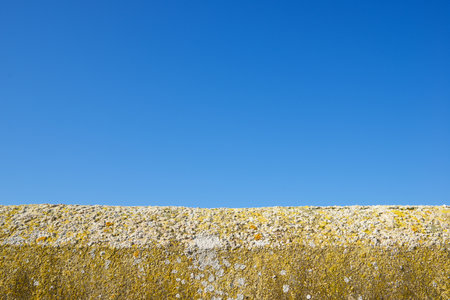 Old and weathered wall with blue and clear skyの写真素材