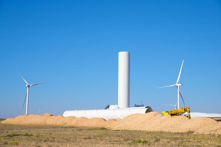 Construction of a windmill for sustainable electrical energy production at sunriseの写真素材