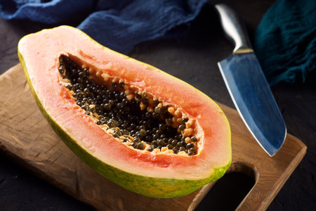 Papaya chunk on a black tableの写真素材