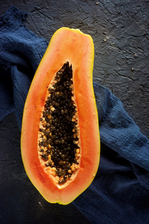 Papaya chunk on a black tableの写真素材