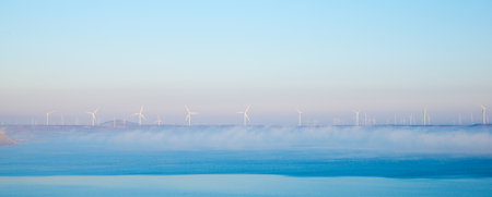 Wind turbine generators for clean electrical energy production and Loteta Lake in Zaragoza Province