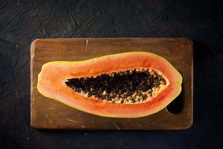 Papaya chunk on a black tableの写真素材
