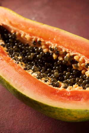 Papaya chunk on a brown tableの写真素材