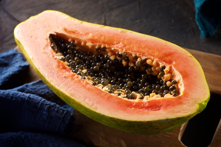 Papaya chunk on a black tableの写真素材