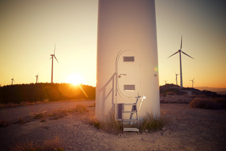 Entrance to wind turbine generator for sustainable electricity production at sunsetの写真素材