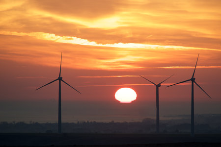 Wind turbine generators for sustainable electrical energy production at sunriseの写真素材