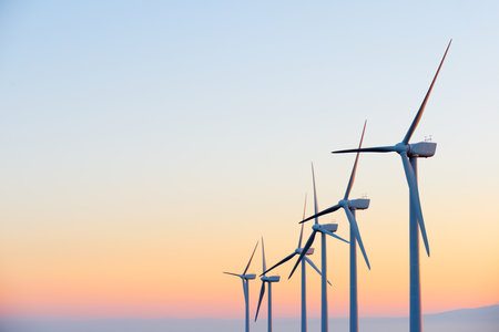 Wind turbine generators for sustainable electrical energy production at sunriseの写真素材