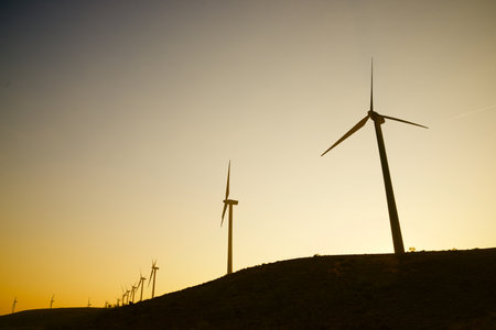 Wind turbine generators for sustainable electrical energy production at sunriseの写真素材