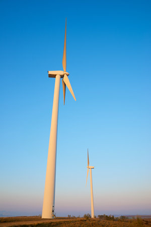 Wind turbine generators for sustainable electrical energy production at sunriseの写真素材