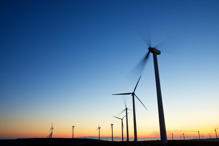 Wind turbine generators for sustainable electrical energy production at sunriseの写真素材